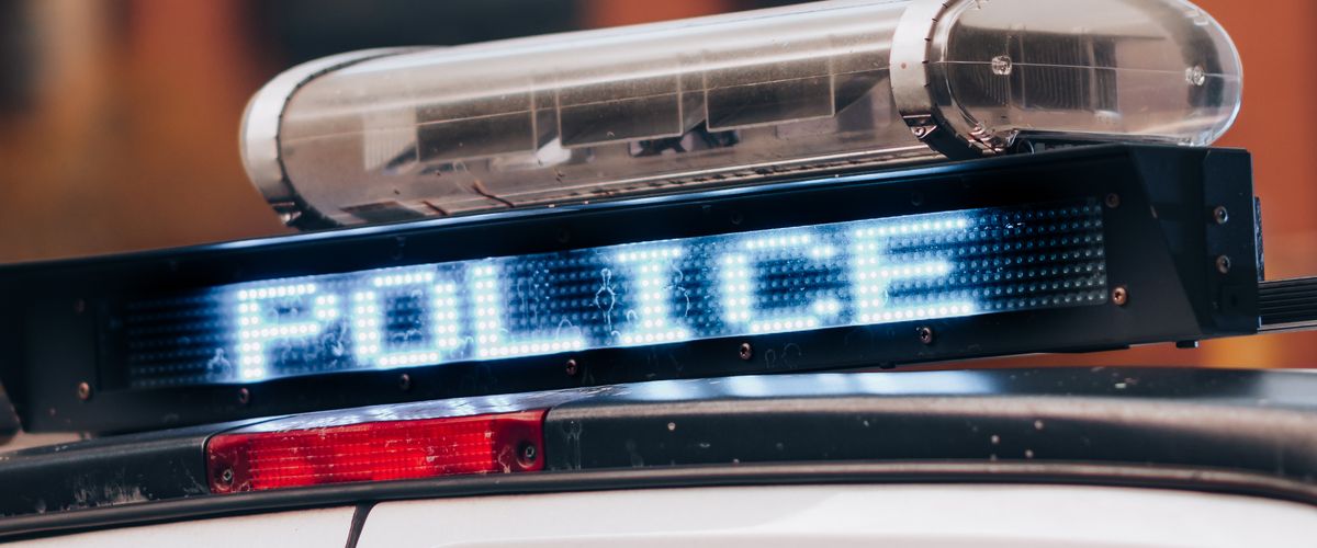 Police car with emergency lights responding to an accident scene