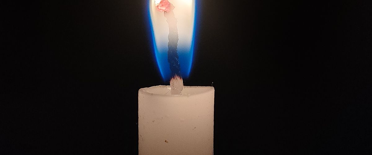 A single lit candle in remembrance